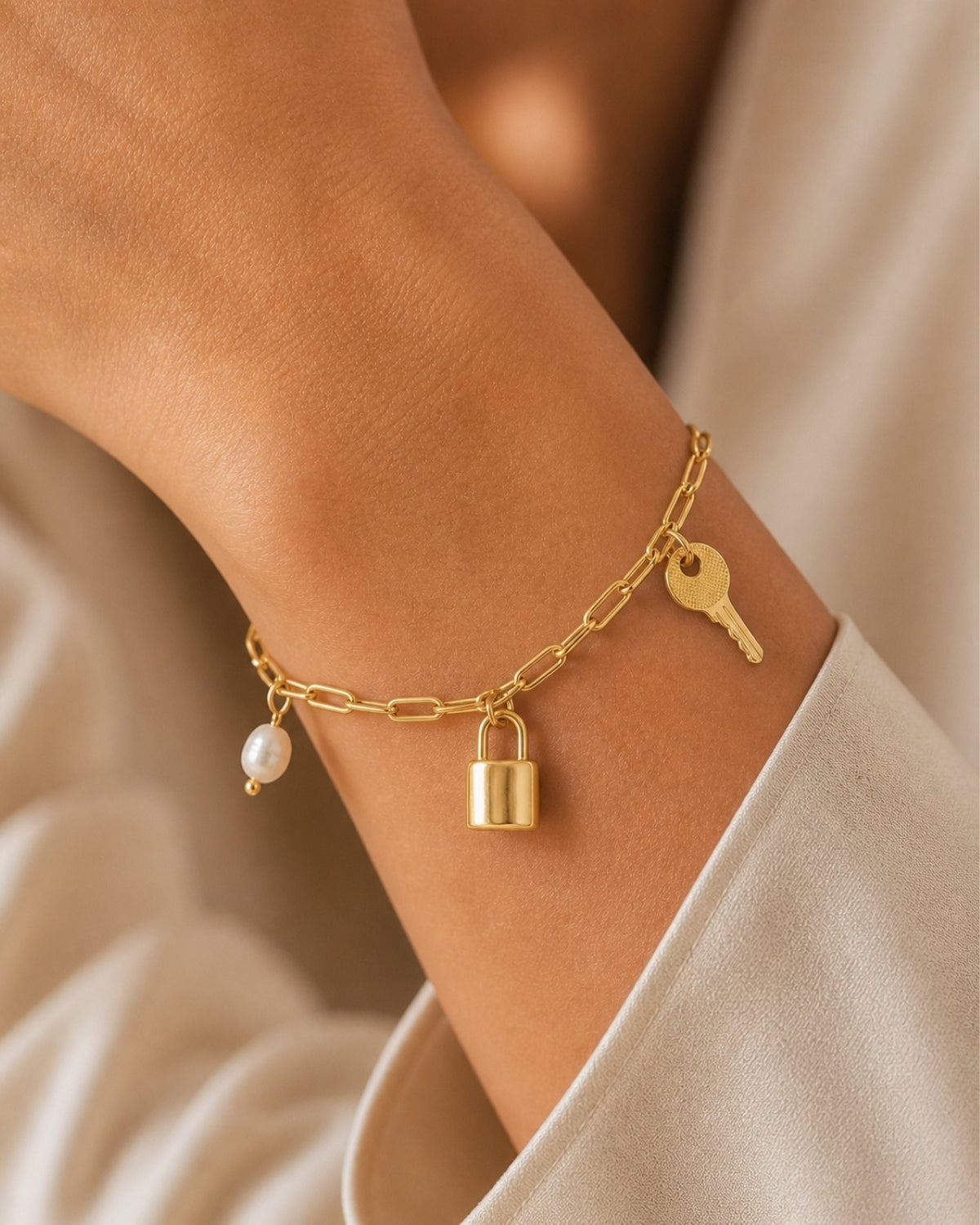 Schakelarmband met bedels en parel